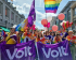 Volters wearing and holding rainbow flags and Volt flags at a Pride march