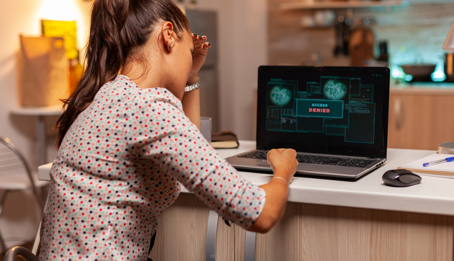 woman sitting in front of her laptop which shows 
