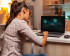 woman sitting in front of her laptop which shows 