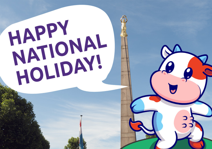 Cow mascot in front of the Golden Lady wishing a happy national holiday