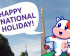 Cow mascot in front of the Golden Lady wishing a happy national holiday