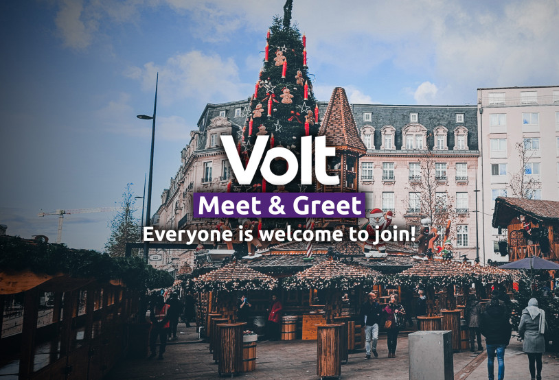 Volt Meet & Greet. Everyone is welcome to join. In the background a big christmas tree and some christmas market huts are seen at the Place de Paris in Luxembourg city.