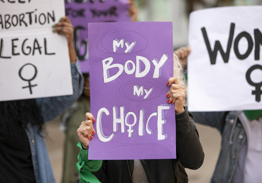 Women holding posters which read 