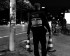 German police officer carrying two traffic cones onto a street