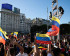 A crowd of people holding up Venezuelan flags and mobile phones